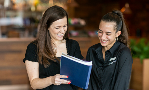 2 colleagues looking at a book